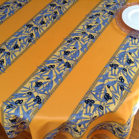 blue and yellow plastic coated French tablecloth with olive designs
