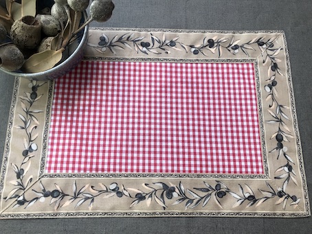 red and white check coated placemats with a border of olives 